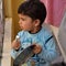 Sweet boy playing bells with spoon to in the Balcony during corona virus lockdown to give respect to doctors in IndiaÂ 